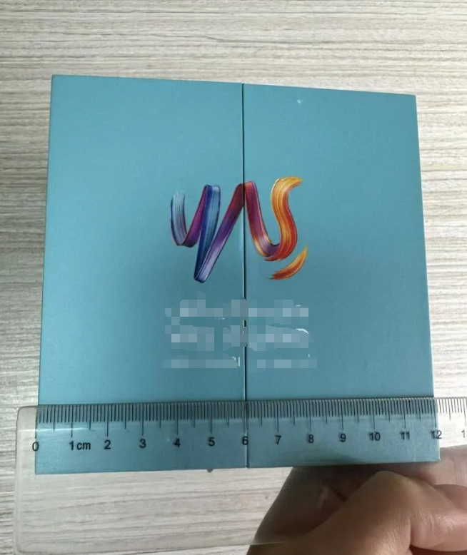 Hands measuring packaging prototypes