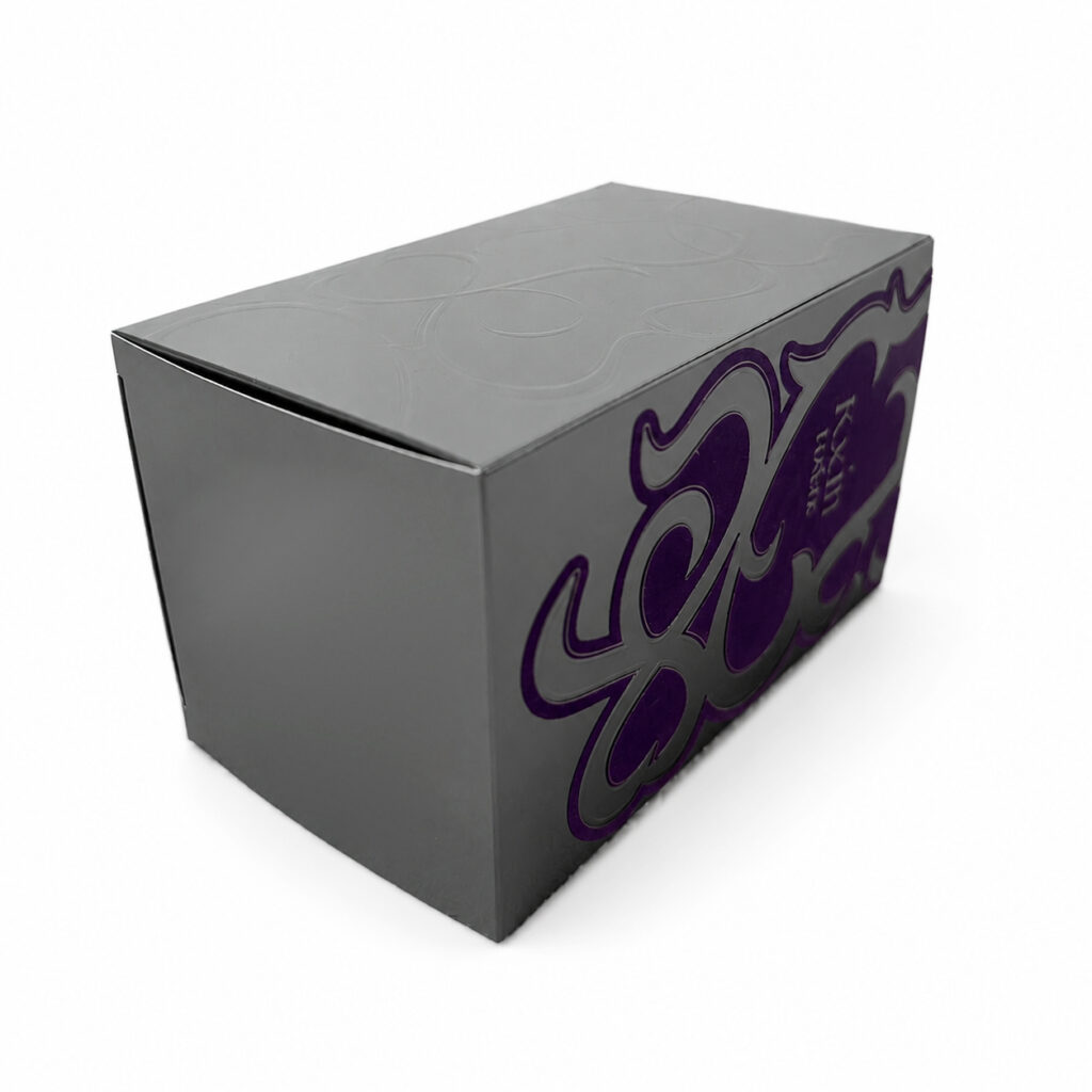 Embossed and flocked design on luxury silver folding carton packaging